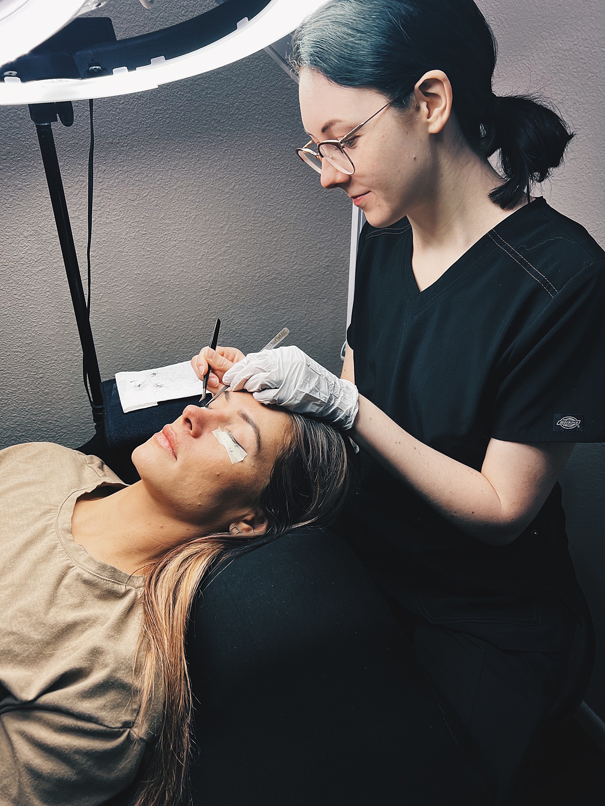 Prescott, AZ lash artist, Nicole Cronauer, is photographed in the lash studio at Natural Beauty by Kelly as she applies lash extensions to a client.