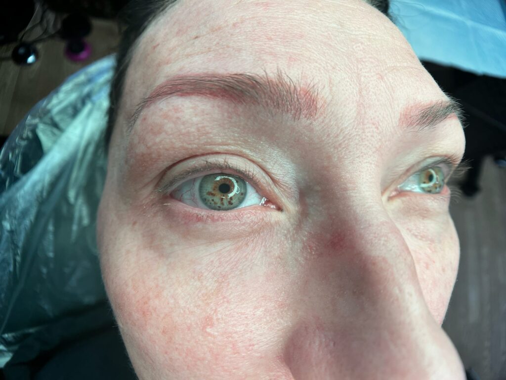 Close up image of a powder brow & eyeliner client ready for touch-up at Natural Beauty by Kelly, an Arizona permanent makeup artist