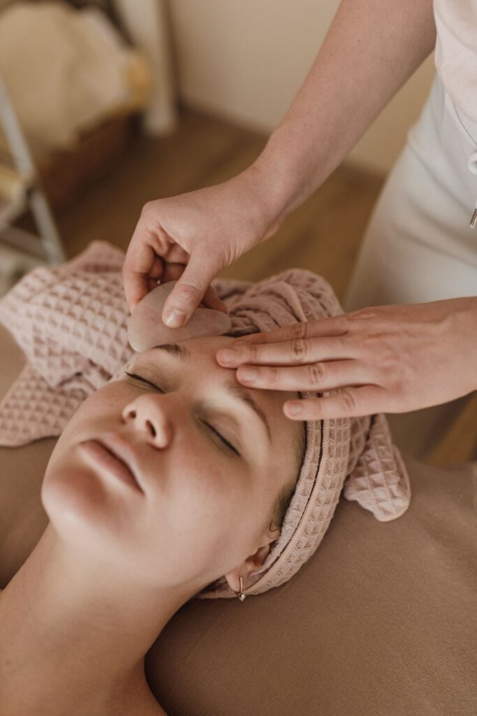 An esthetician in Prescott AZ demonstrates a gua sha facial 